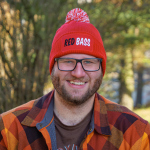 Winter knitted beanie with pom-pom REDBASS with a patch